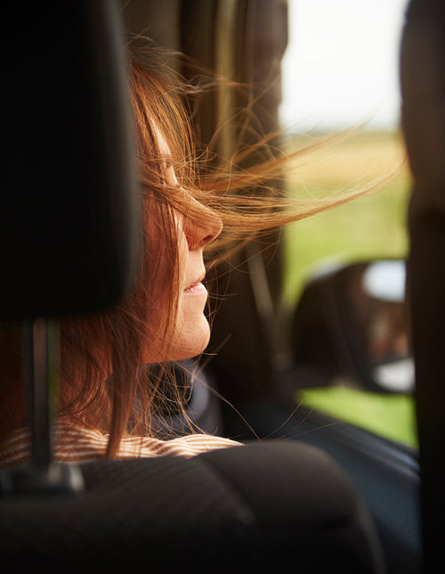 Rear view of woman enjoying the view during road trip