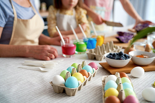 Close up of dyeing Easter eggs in the family circle