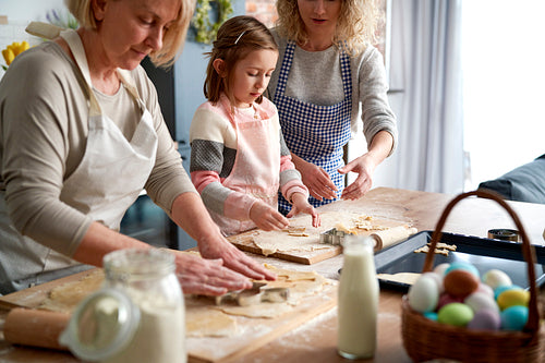 Three generations of women making Eater cookies together