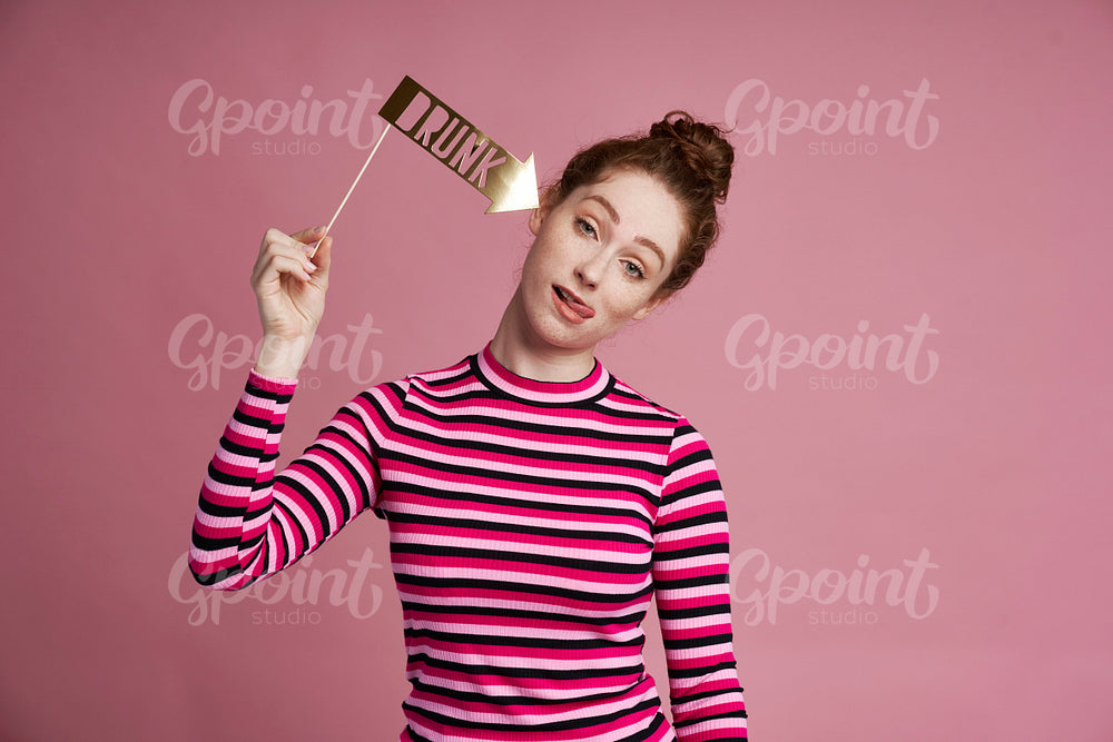Studio shot of young woman with funny card 