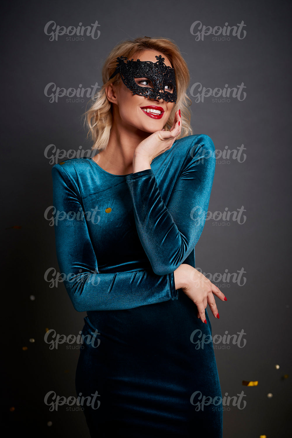 Beautiful woman with masquerade mask looking at copy space