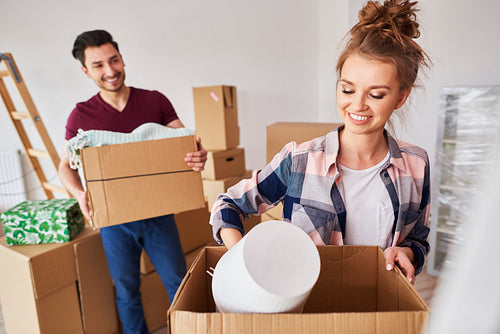 Couple packing their stuff into boxes during move house