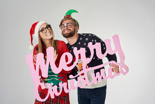 Couple wishing Merry Christmas to all