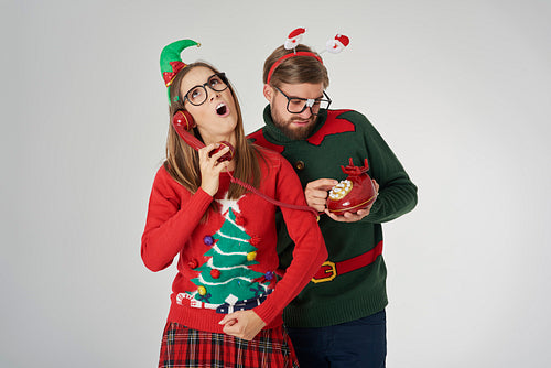 Christmas couple calling by retro telephone