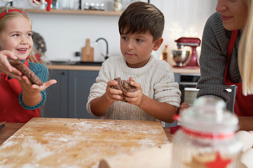 Children preparing cookies with gingerbread pastry