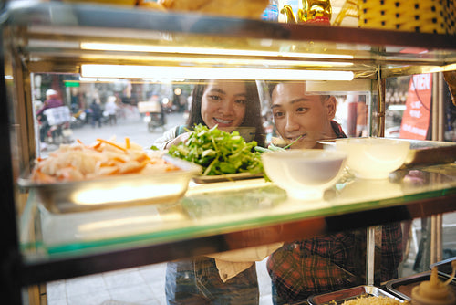 Asian couple choosing some street food