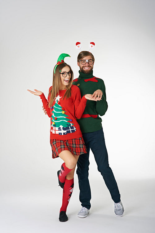 Funny couple wearing weird Christmas sweaters