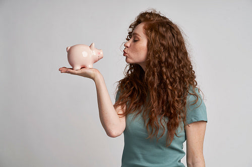 Woman blowing kisses to her savings