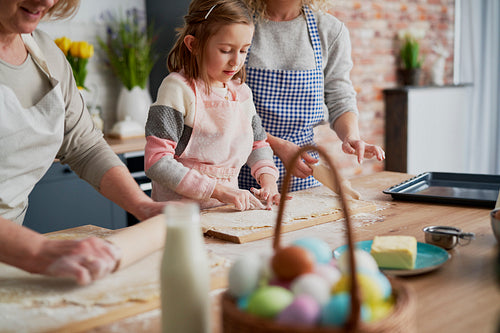 Little girl helping during Easter baking in the kitchen