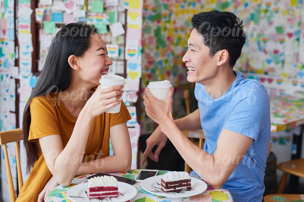 Cheerful couple have interesting discussion in a cafe