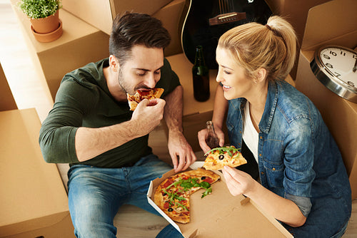 Couple moving house eating pizza