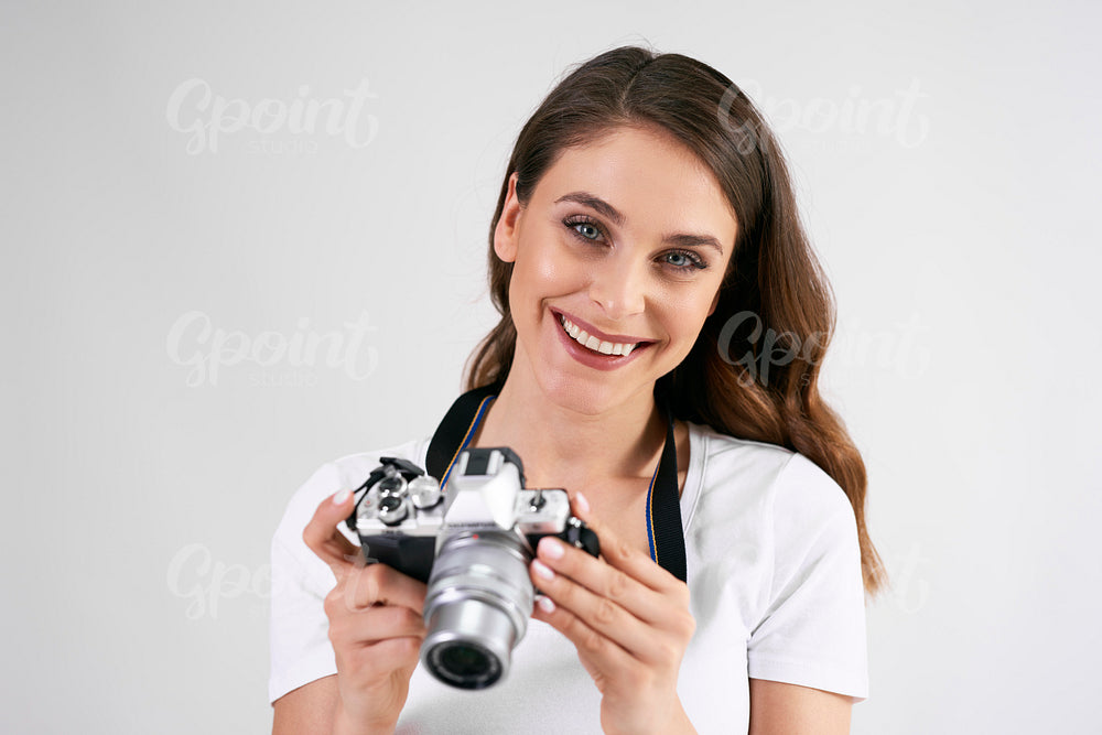 Portrait of smiling woman holding a camera