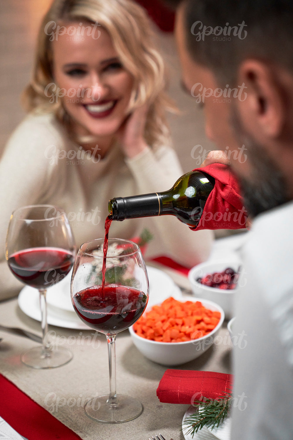 Happy couple drinking wine during Christmas dinner