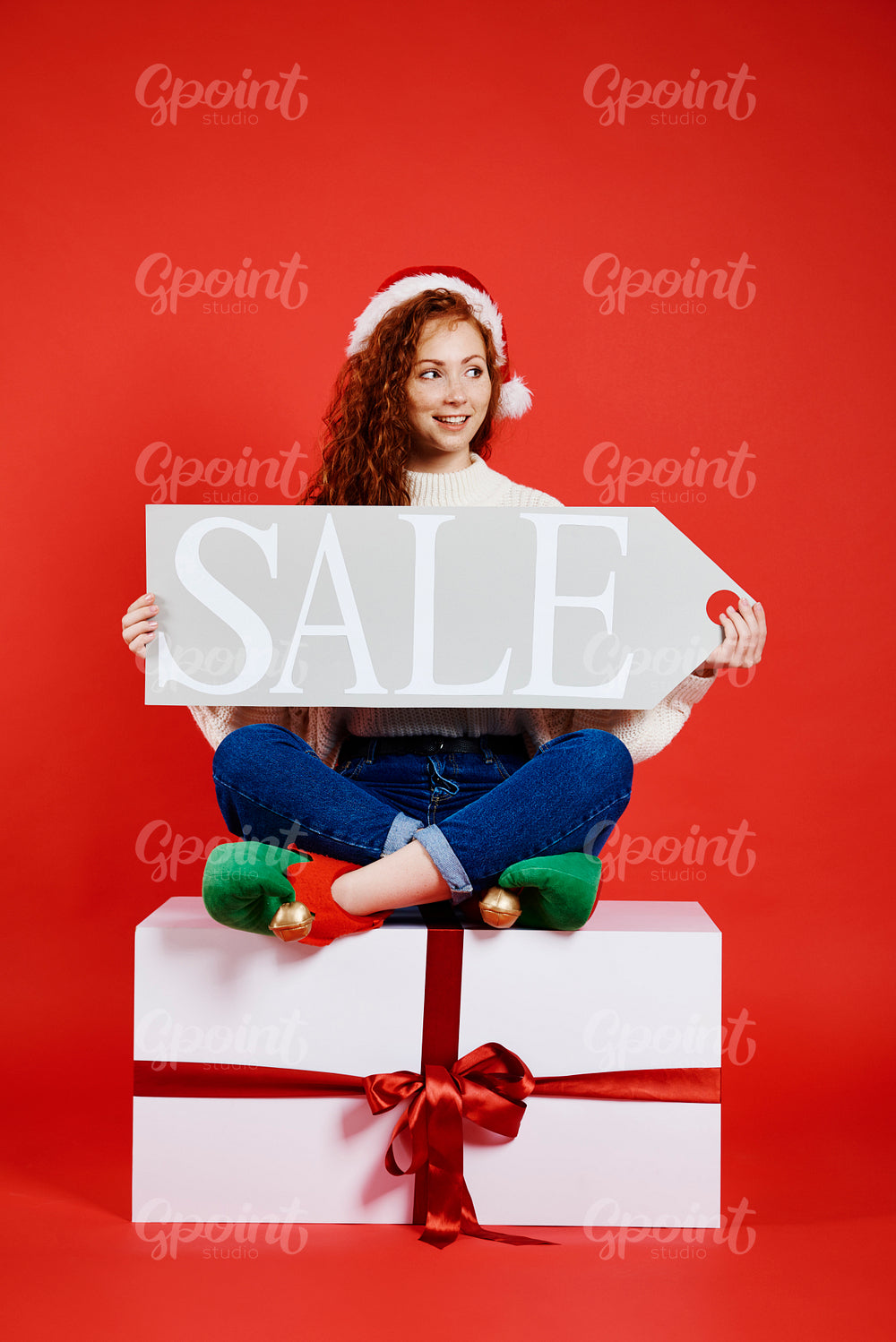 Happy woman holding banner of christmas sale