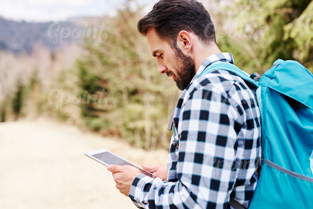 Mature man choosing the best path for hiking