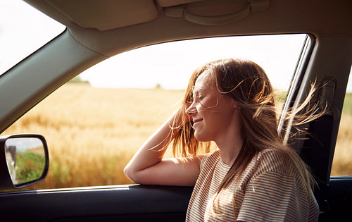 Dreaming woman traveling by car
